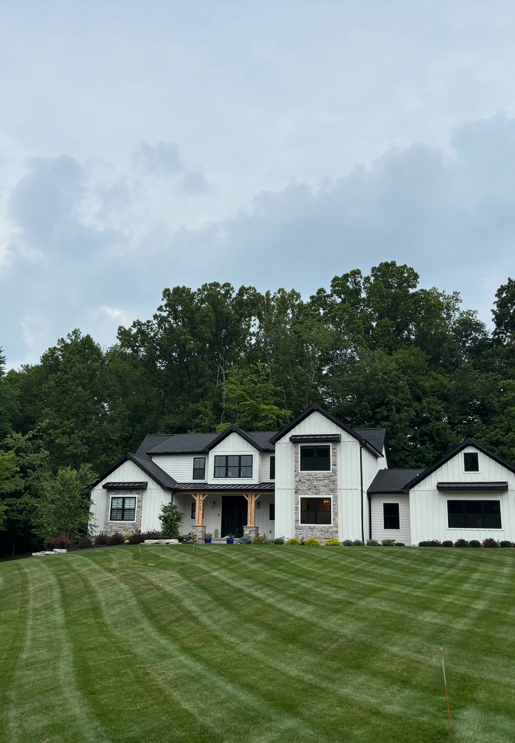 Freshly mowed and striped residential lawn maintained by DG Picture Perfect Landscaping in Cuyahoga County, Ohio