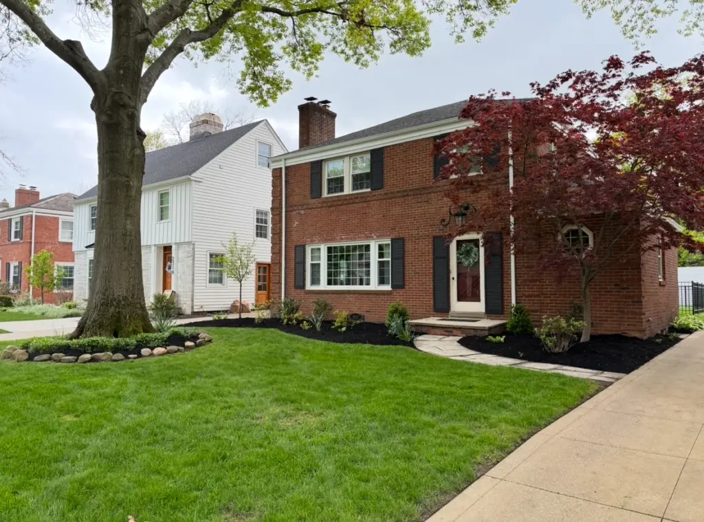 Residential landscaping with fresh mulch beds, trimmed shrubs, and curb appeal enhancement in Northeast Ohio