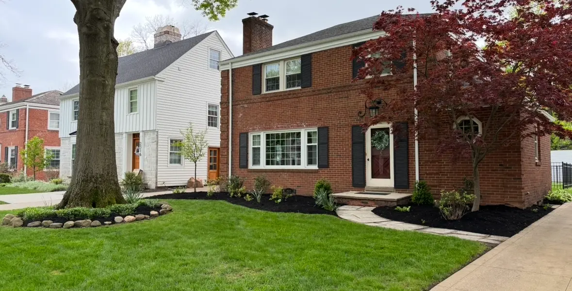 Residential landscaping with fresh mulch beds, trimmed shrubs, and curb appeal enhancement in Northeast Ohio