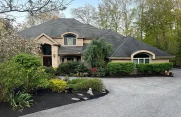 Residential landscaping with fresh mulch beds, trimmed shrubs, and curb appeal enhancement in Northeast Ohio