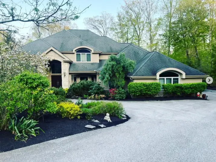 Landscape bed maintenance and fresh mulch at a Northeast Ohio stone home