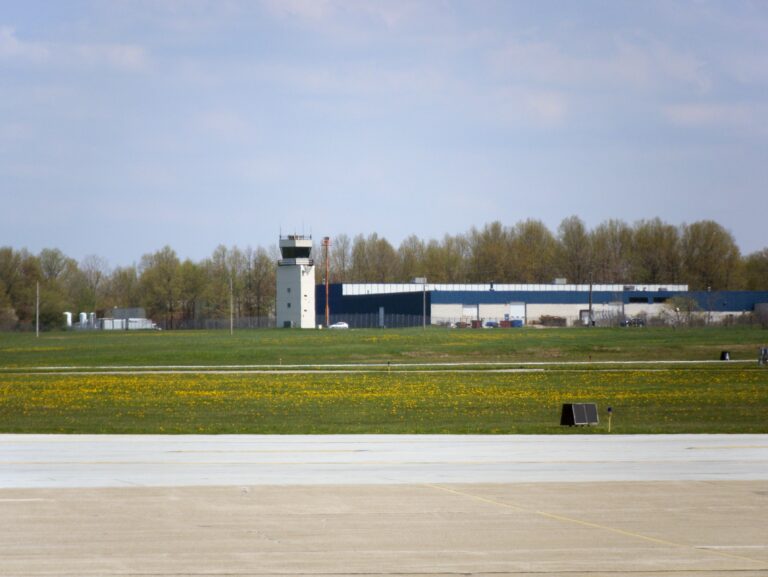 Cuyahoga County Airport control tower in Highland Heights with a green grass field in the foreground