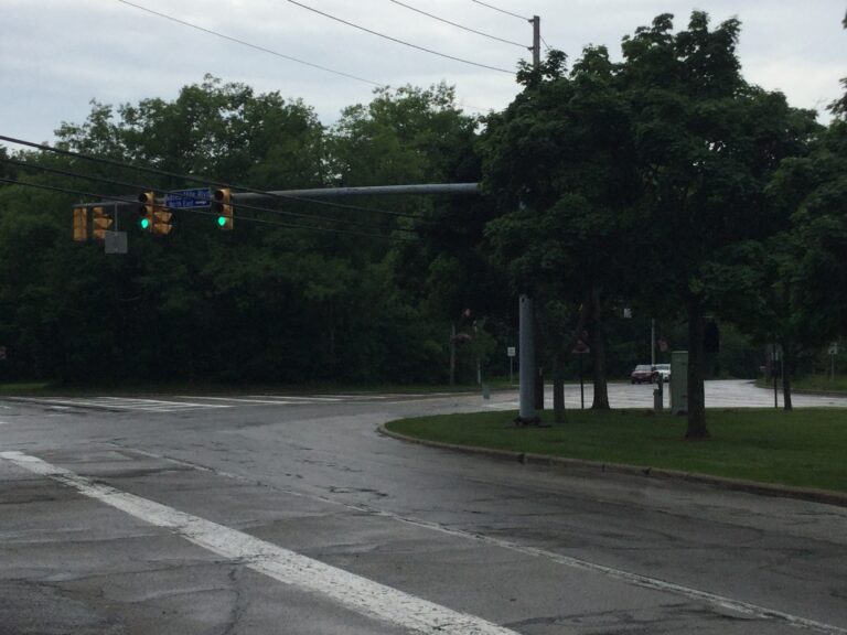 Cedar Road at Gates Mills Boulevard in Pepper Pike, under a dense green tree canopy