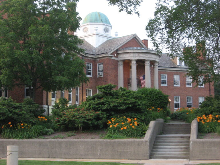 Shaker Heights City Hall framed by mature trees and flowering shrubs