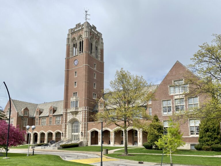 Administration building at John Carroll University in University Heights, with a green tree in the foreground