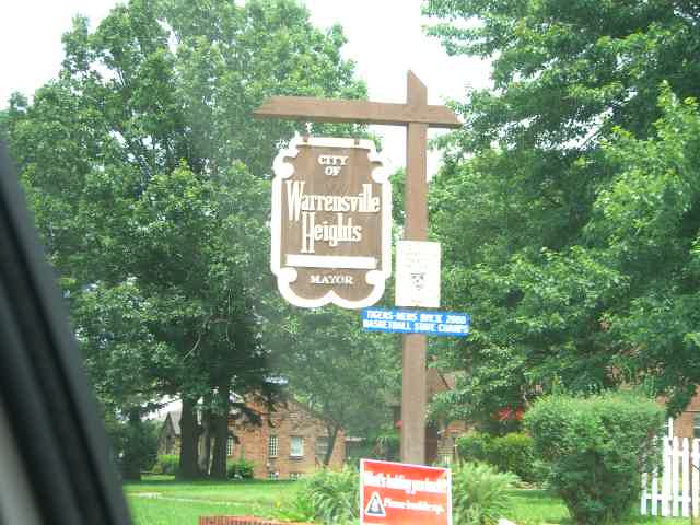 City of Warrensville Heights welcome sign framed by street-tree greenery